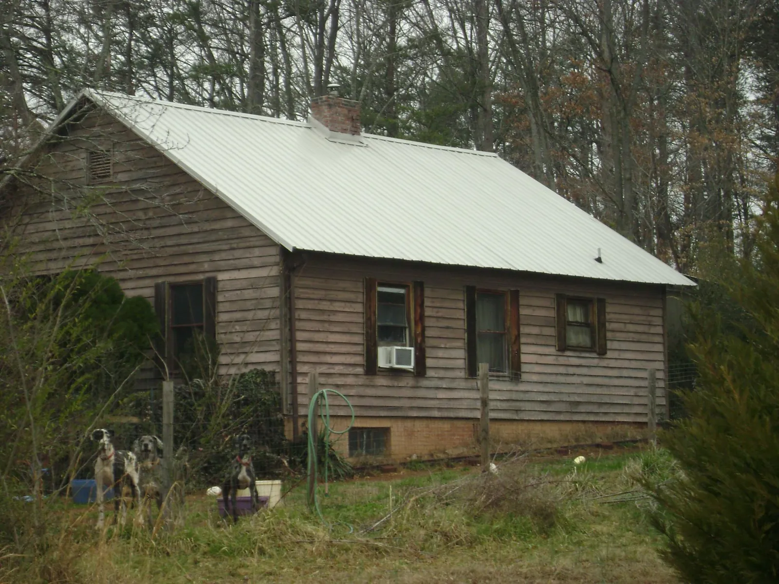 White metal roof on an old wood sided farmhouse, from a Metal Roof Installation job in Loves Park